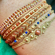 Pulsera Trenza Hecha a Mano en Tonos Cobre, Naranja y Dorado